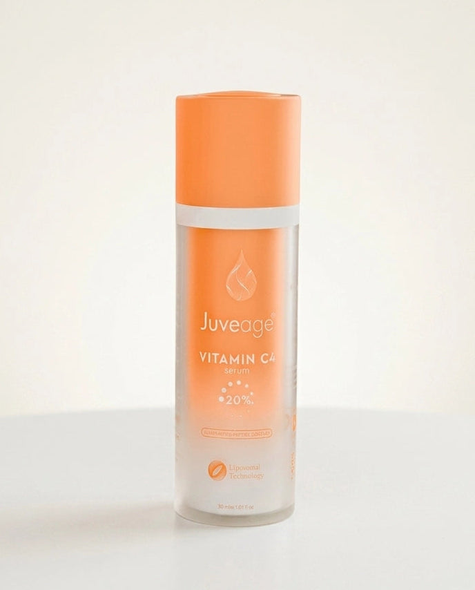 A bottle of Juveage Vitamin C Serum with a bright orange cap and a frosted glass body showing the orange liquid inside, set against a clean white background.